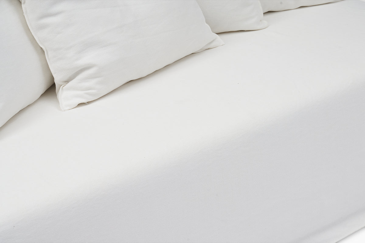 Close-up of white armless sofa corner and back cushions